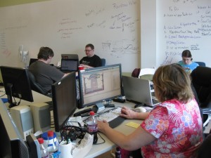 Members of Team Rainbow Kitty work on the game "Scales of Justice" at the April 2012 St. Louis Game Jam.